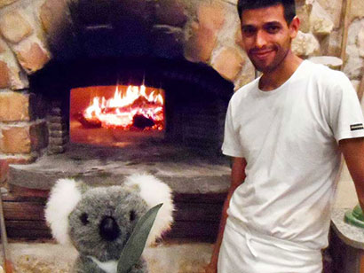 Jimmy in front of pizza oven in Italy